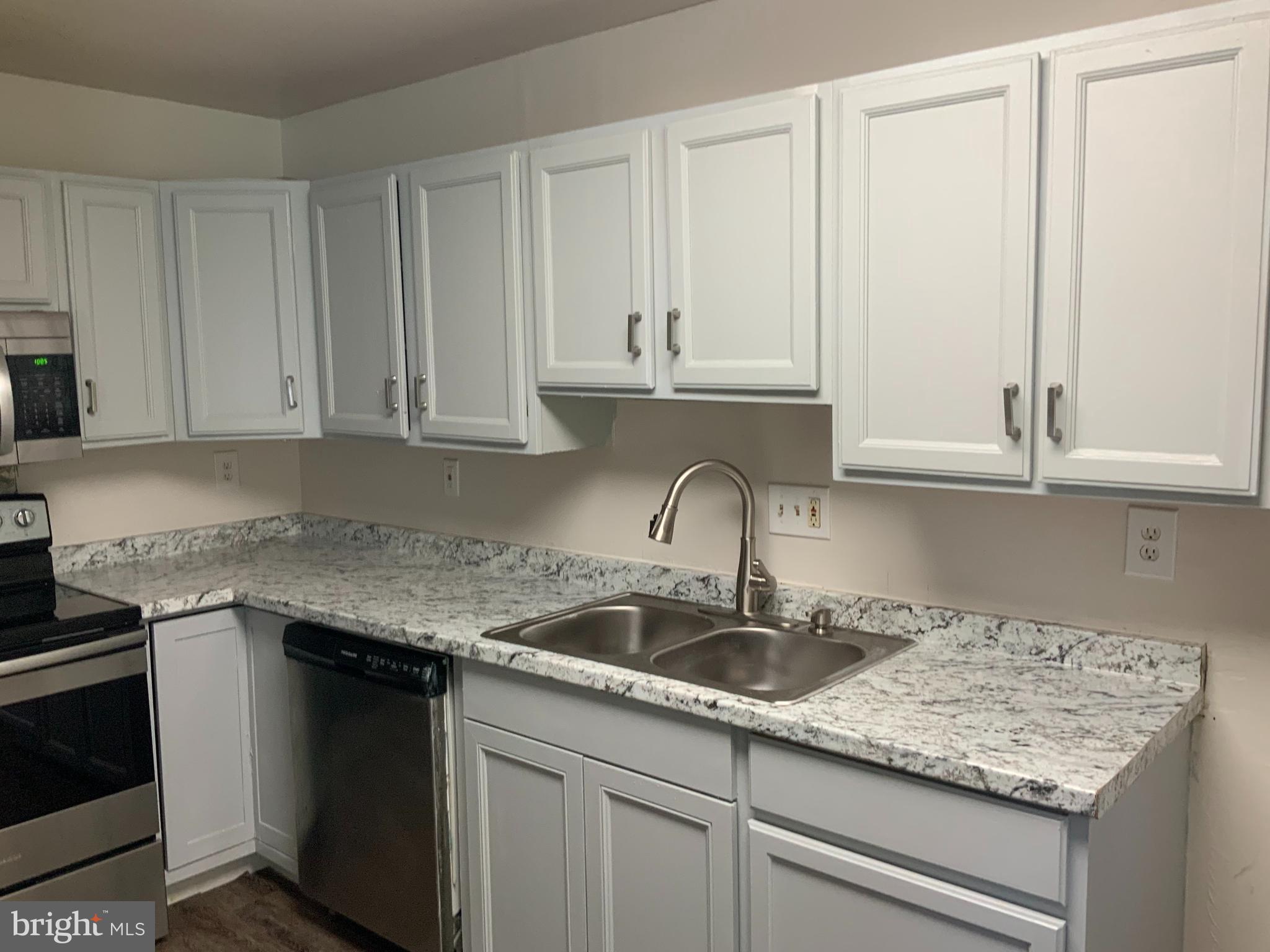 2507 Kingsway Road Fort Washington, MD 20744 - Photo 13 of 39 a kitchen with granite countertop white cabinets and a sink