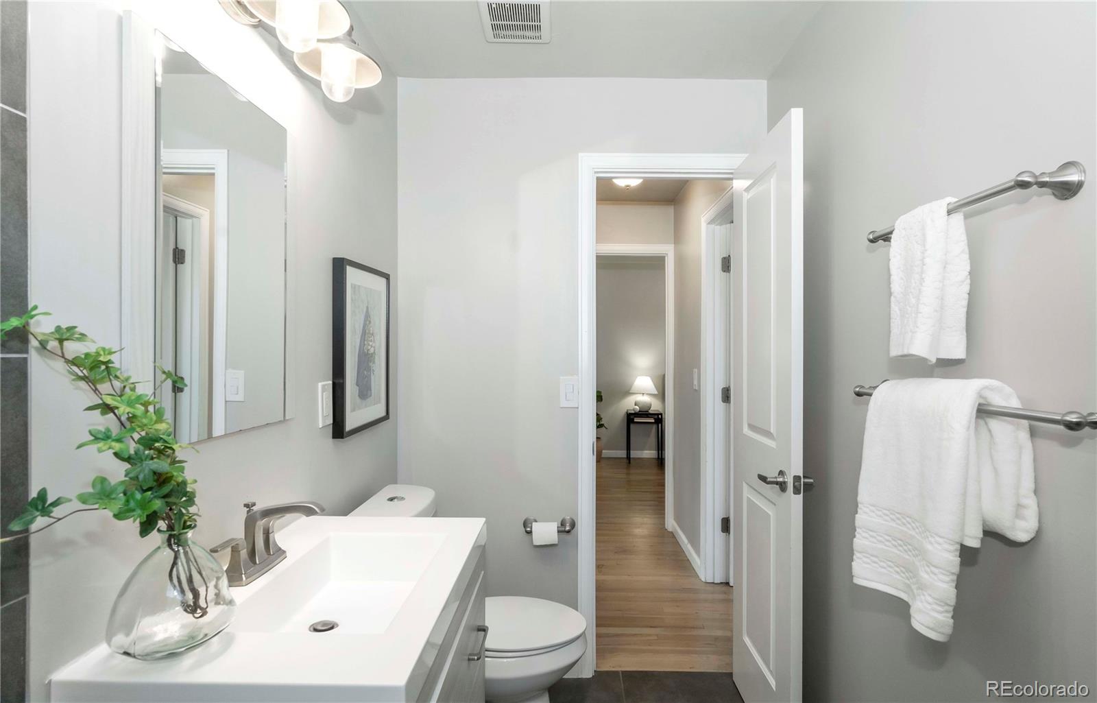 1310 Wolff Street Denver, CO 80204 - Photo 15 of 31 a bathroom with a sink toilet and shower