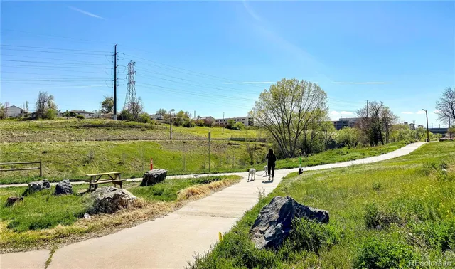 a view of a lake with a yard and large trees