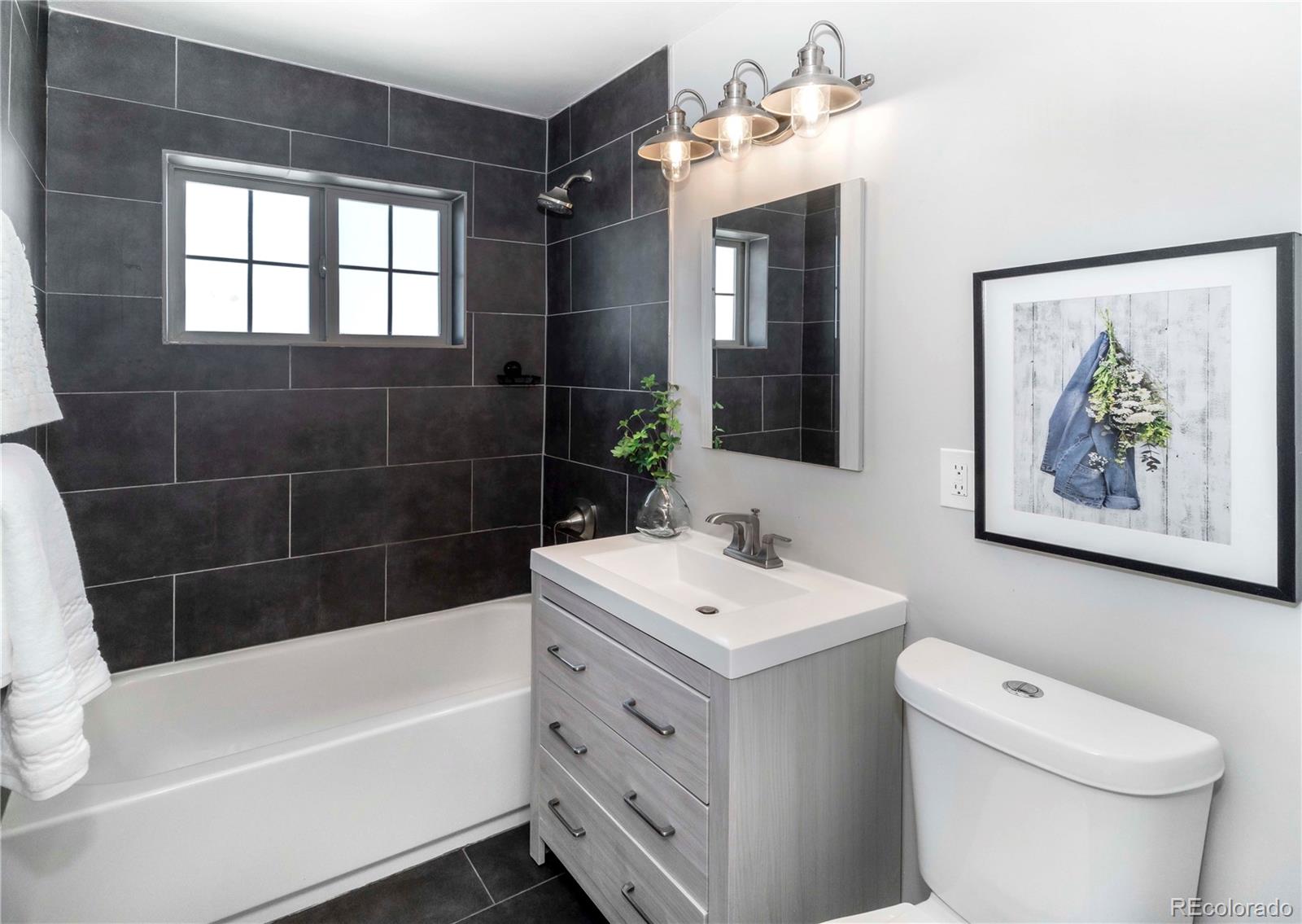 1310 Wolff Street Denver, CO 80204 - Photo 16 of 31 a bathroom with a sink a toilet and bathtub