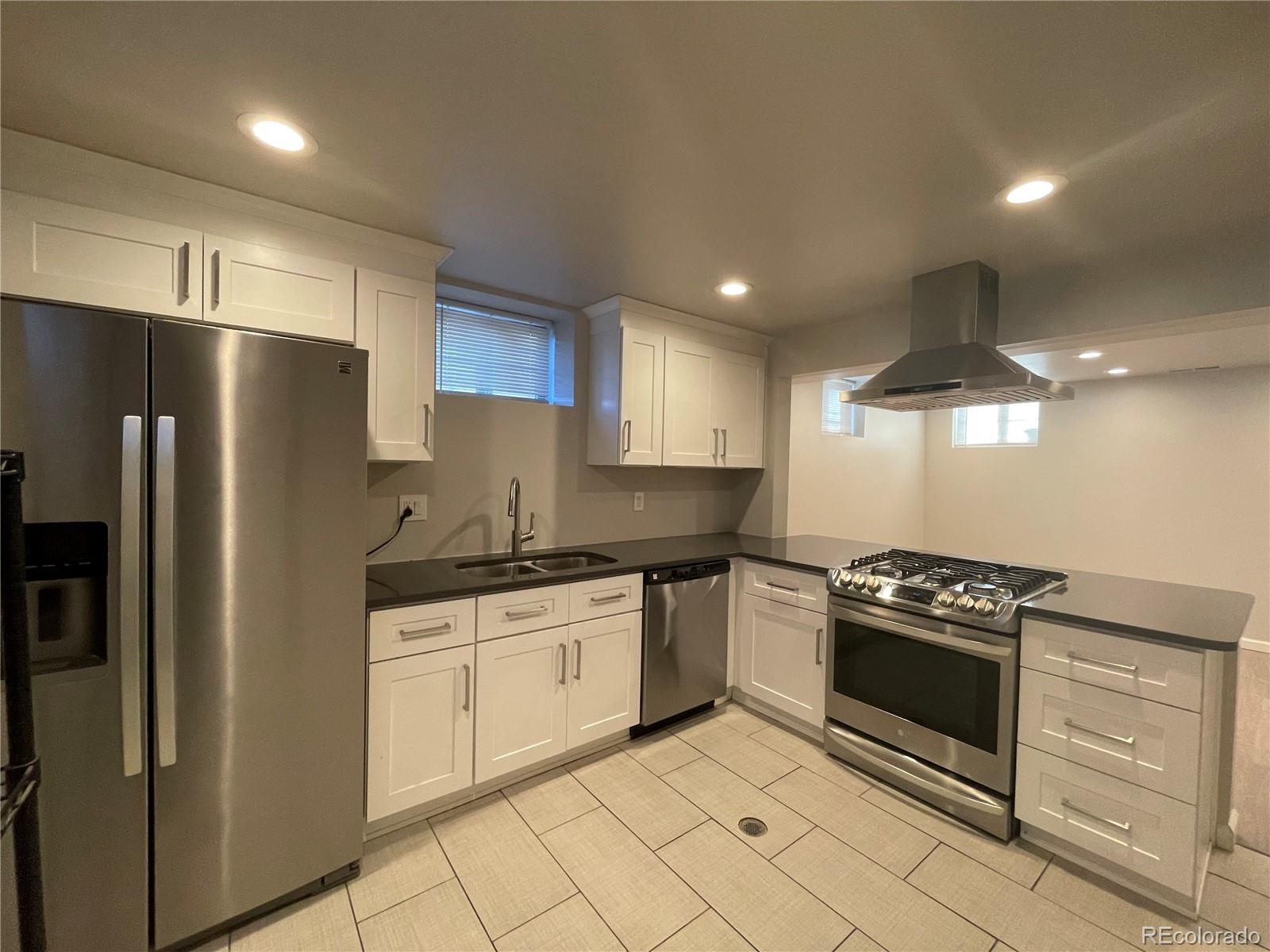 1310 Wolff Street Denver, CO 80204 - Photo 22 of 31 a kitchen with granite countertop a refrigerator stove and sink