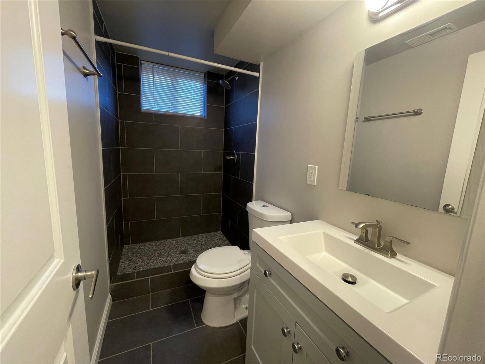 1310 Wolff Street Denver, CO 80204 - Photo 24 of 31 a bathroom with a sink toilet and shower