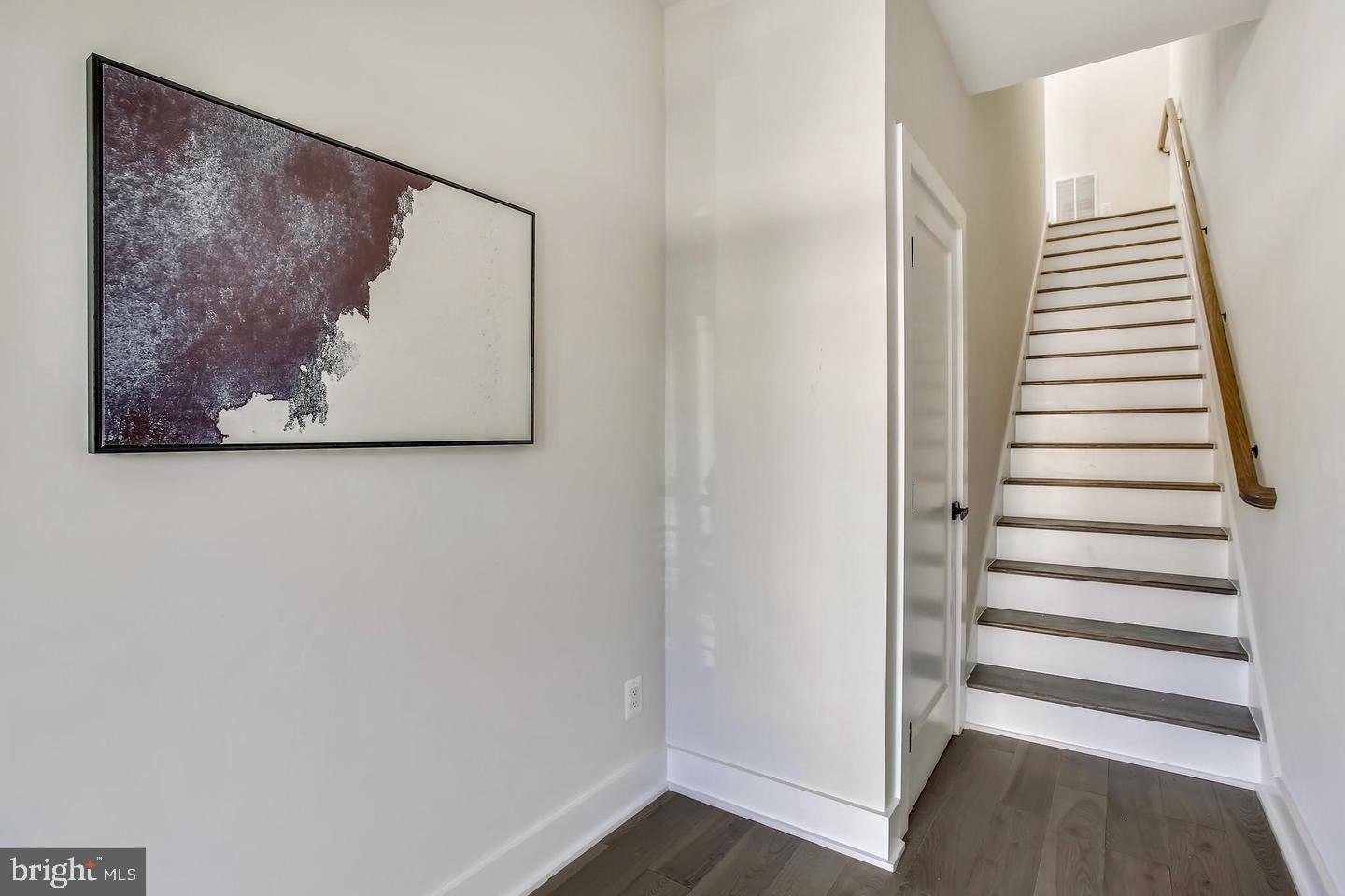 822 Madison Street Northwest Washington, DC 20011 - Photo 12 of 35 a view of a hallway with stairs and a white walls