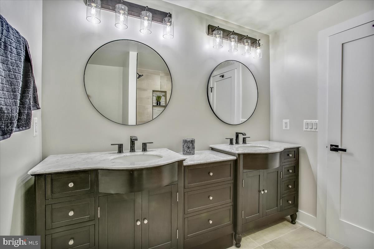 822 Madison Street Northwest Washington, DC 20011 - Photo 15 of 35 a bathroom with a granite countertop double vanity sink and a mirror