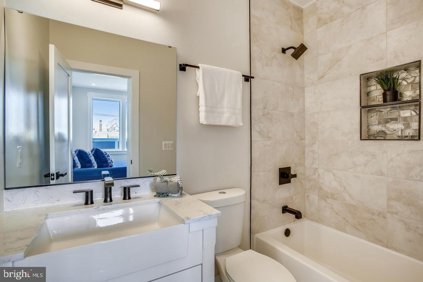 822 Madison Street Northwest Washington, DC 20011 - Photo 19 of 35 a bathroom with a granite countertop sink a toilet and shower