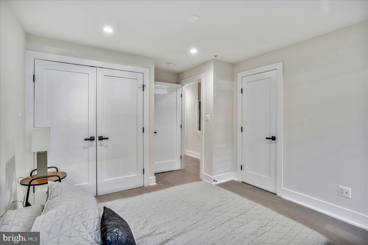 822 Madison Street Northwest Washington, DC 20011 - Photo 23 of 35 a spacious bedroom with a bed and a table