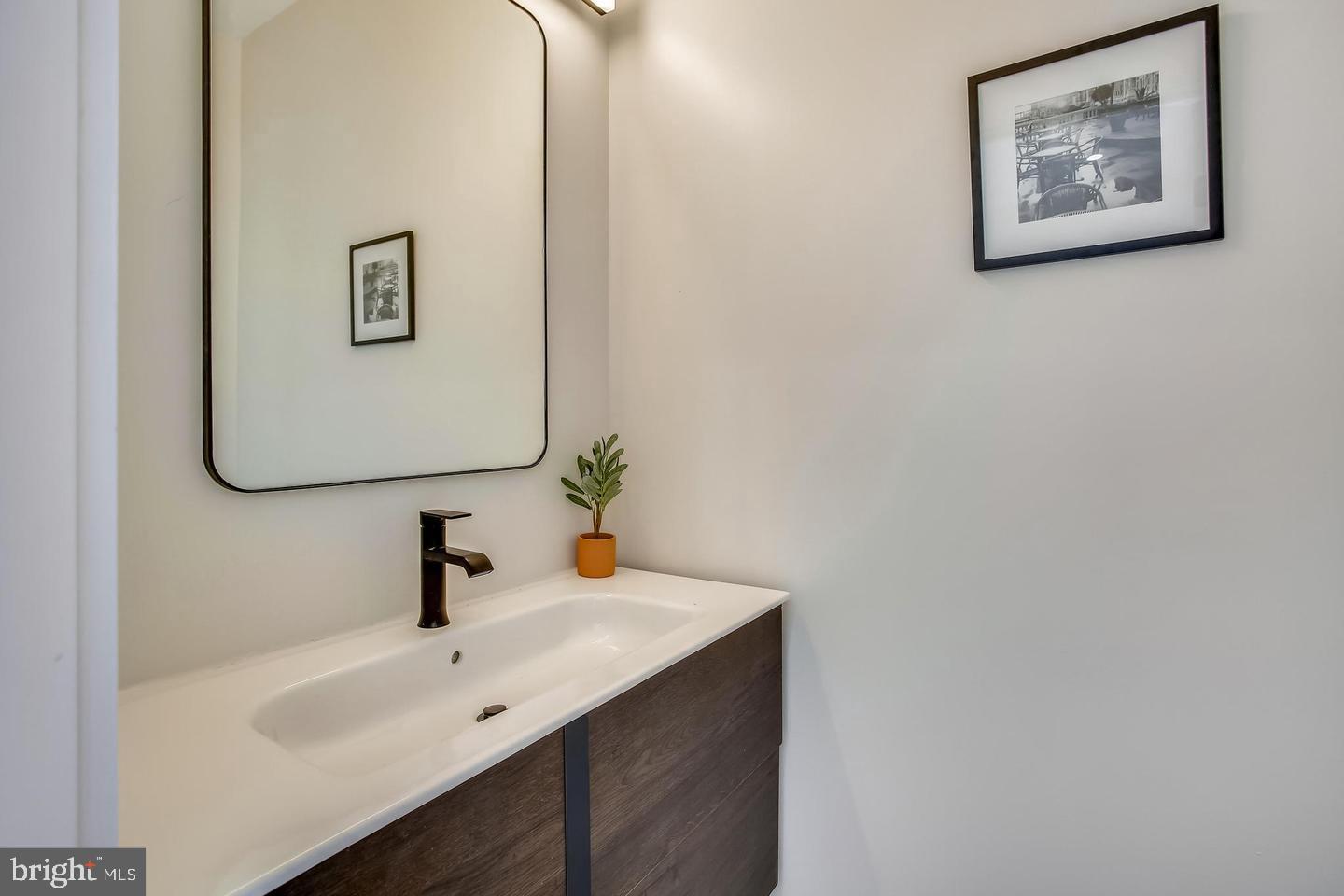 822 Madison Street Northwest Washington, DC 20011 - Photo 29 of 35 a bathroom with a sink and a mirror