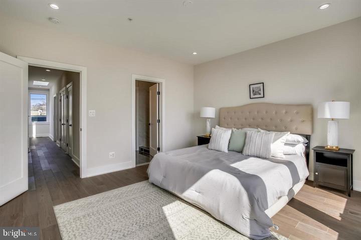 822 Madison Street Northwest Washington, DC 20011 - Photo 9 of 35 a bedroom with a bed and wooden floor
