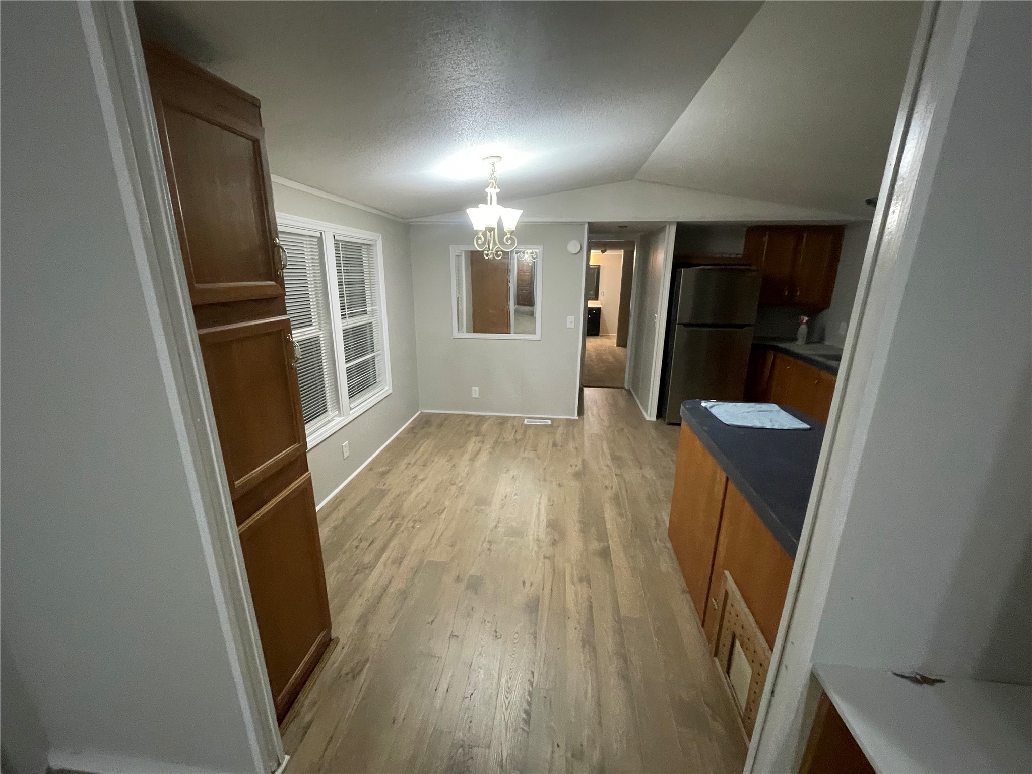 215 Greenfield Road Kyle, TX 78640 - Photo 7 of 8 Vinyl plank flooring extends throughout this versatile living space, brightened by natural light.