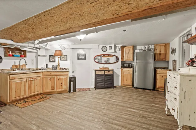 a kitchen with refrigerator cabinets and wooden floor