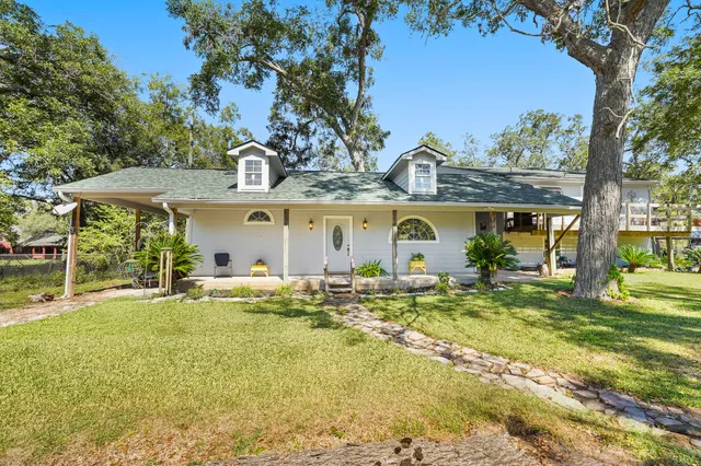 a view of a house with garden and porch