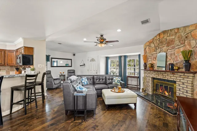 a living room with a fireplace and a window