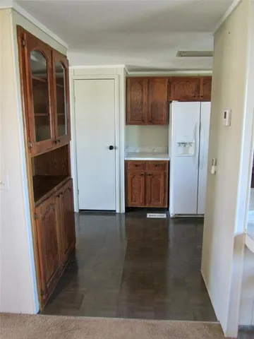 a view of kitchen with refrigerator and wooden floor