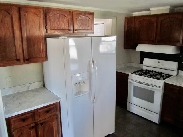 a kitchen with granite countertop cabinets and steel stainless steel appliances