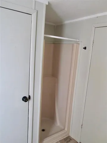 a bathroom with a glass shower door