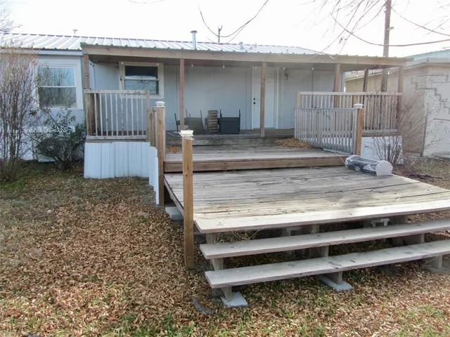 a view of a house with a wooden fence