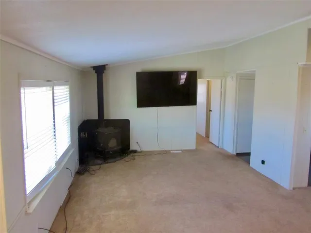 a living room with a flat screen tv and a window