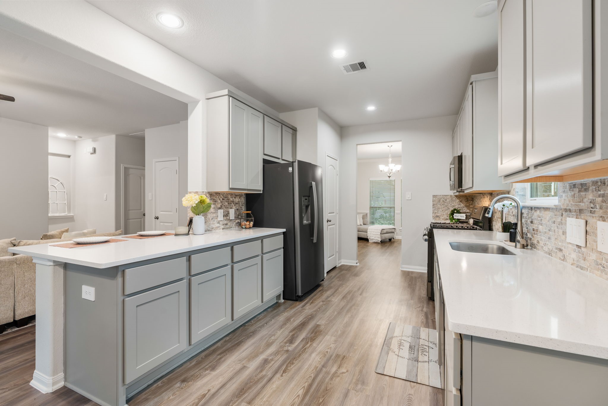 16680 Rockwall Street Conroe, TX 77303 - Photo 12 of 38 Kitchen features slate slate appliances, quartz countertops and designer backsplash.
