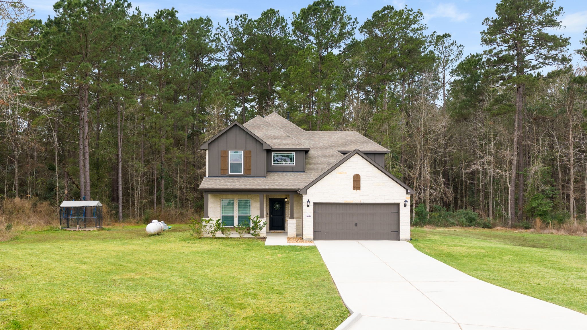 16680 Rockwall Street Conroe, TX 77303 - Photo 37 of 38 This home features an elevated CE floorplan with beautiful stone and brick front and a large covered front porch.
