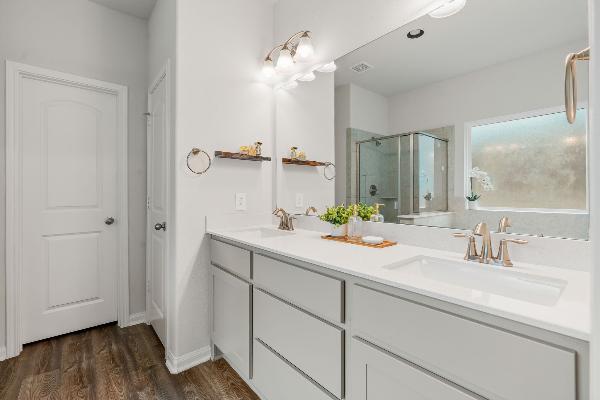 16680 Rockwall Street Conroe, TX 77303 - Photo 20 of 38 Double sinks and a walk-in closet with shelving.