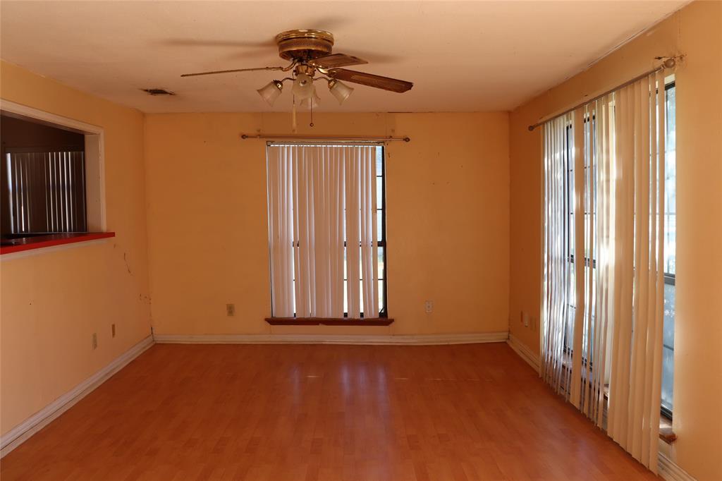 916 Poindexter Avenue Cleburne, TX 76033 - Photo 3 of 10 a view of a livingroom with a ceiling fan and window