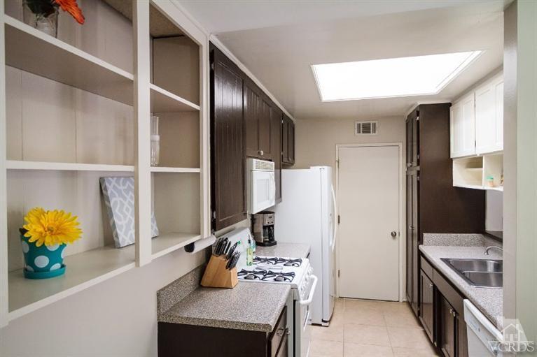 169 Ripley Street Camarillo, CA 93010 - Photo 4 of 17 a kitchen with stainless steel appliances cabinets and a window