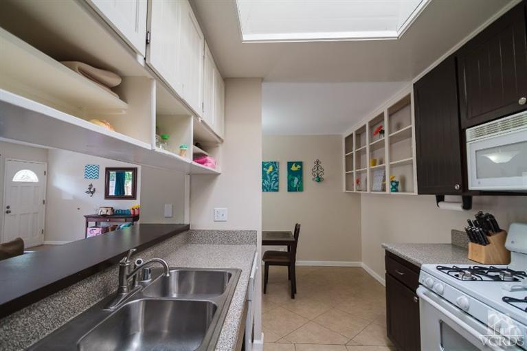 169 Ripley Street Camarillo, CA 93010 - Photo 5 of 17 a kitchen with a stove and a white cabinets