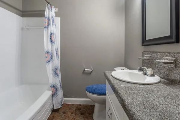 a picture of a bathroom with a sink and a mirror