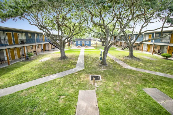 a view of yard with swimming pool and trees