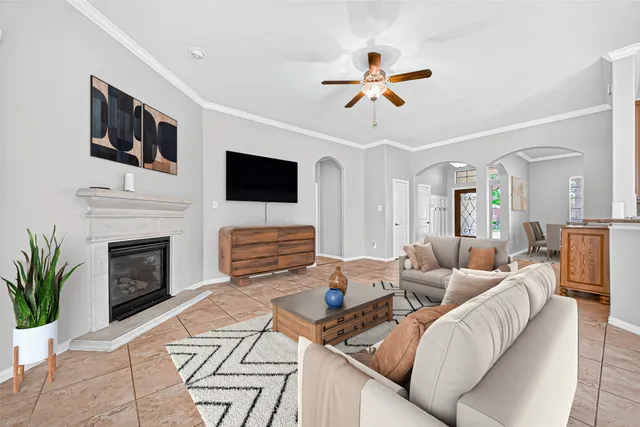 a living room with furniture a fireplace and a flat screen tv