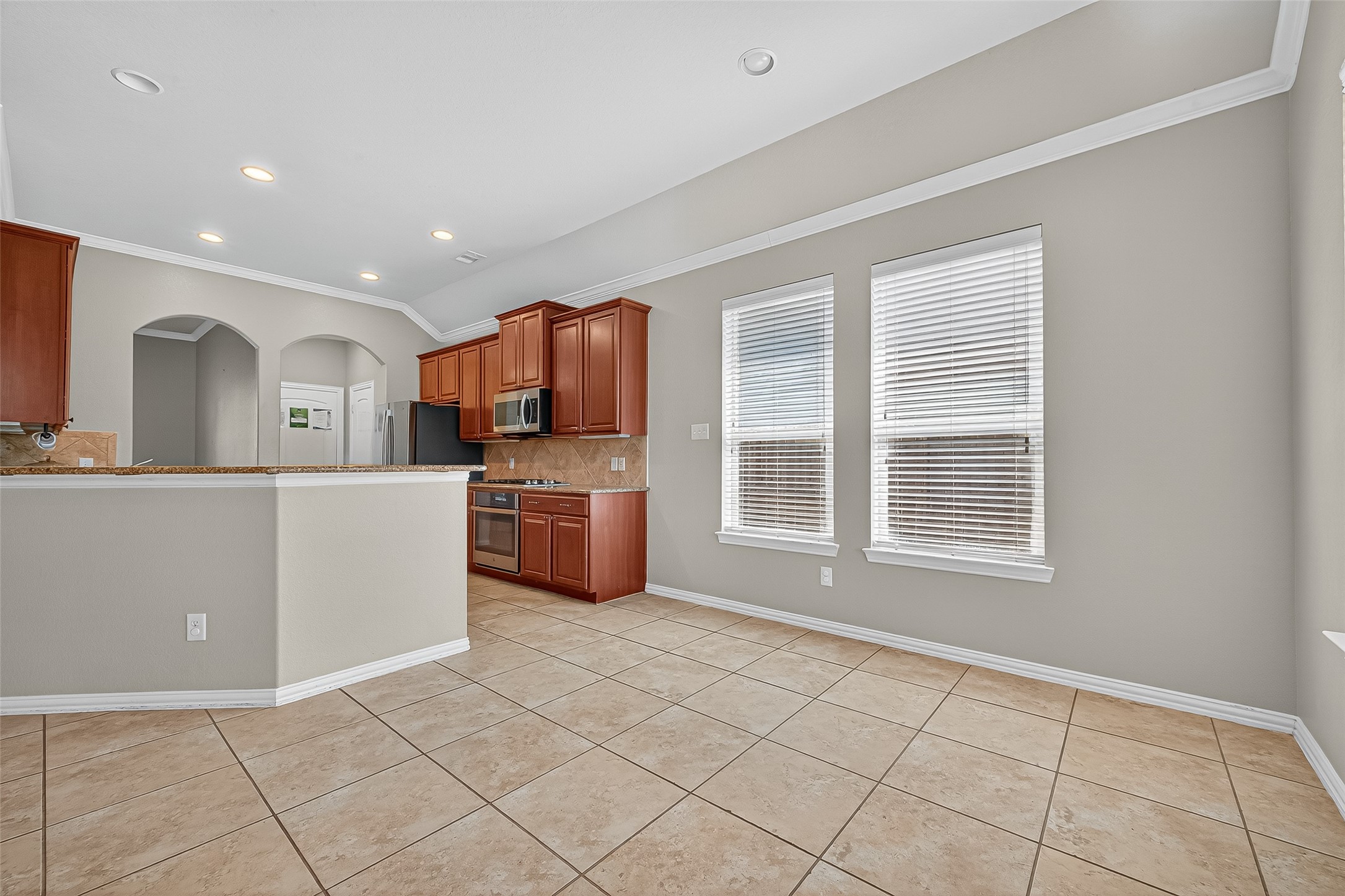 2019 Preston Park Rosenberg, TX 77471 - Photo 14 of 31 a kitchen with granite countertop a sink a counter top space cabinets and stainless steel appliances