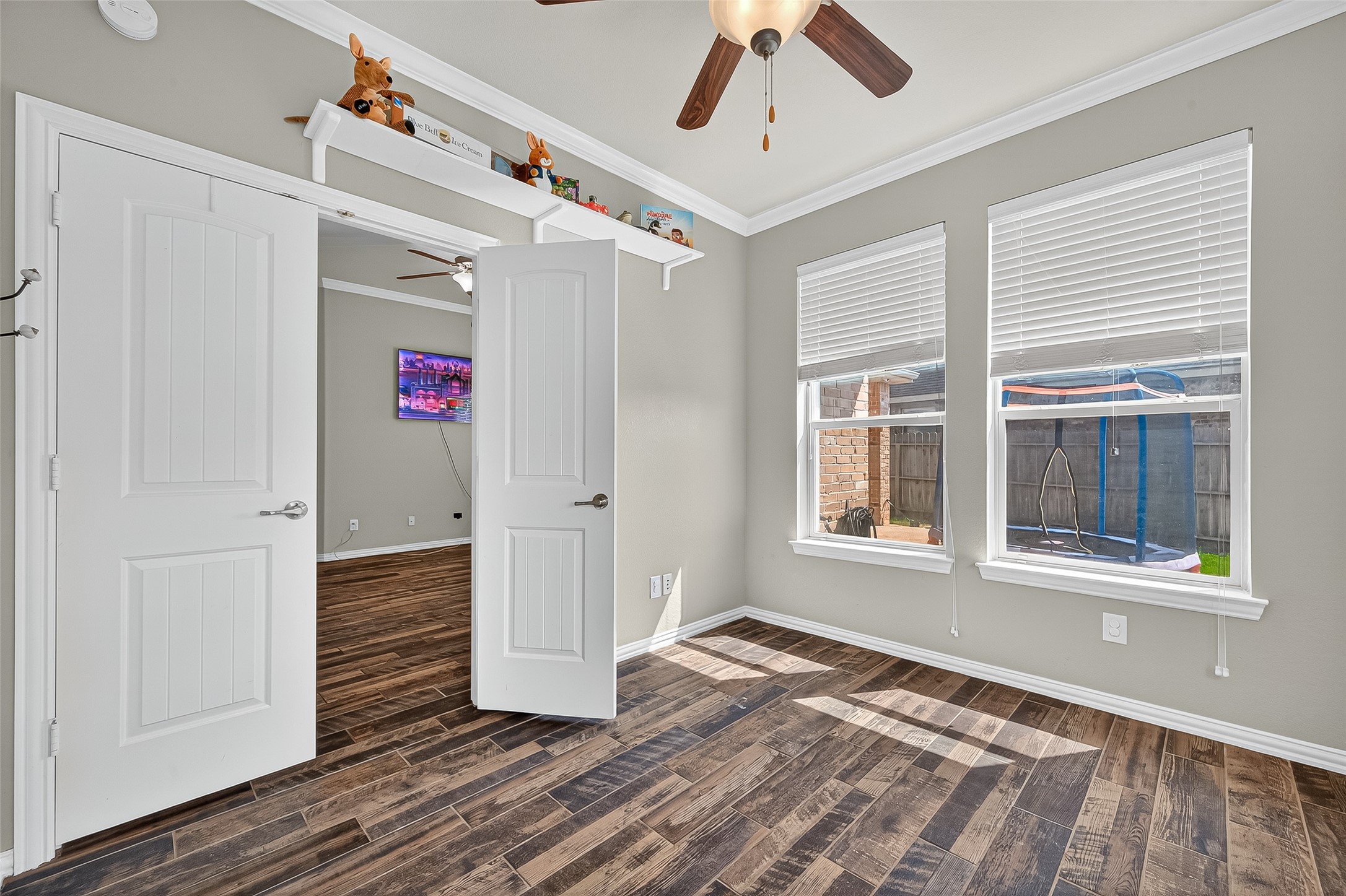 2019 Preston Park Rosenberg, TX 77471 - Photo 17 of 31 a view of an empty room with wooden floor and a window