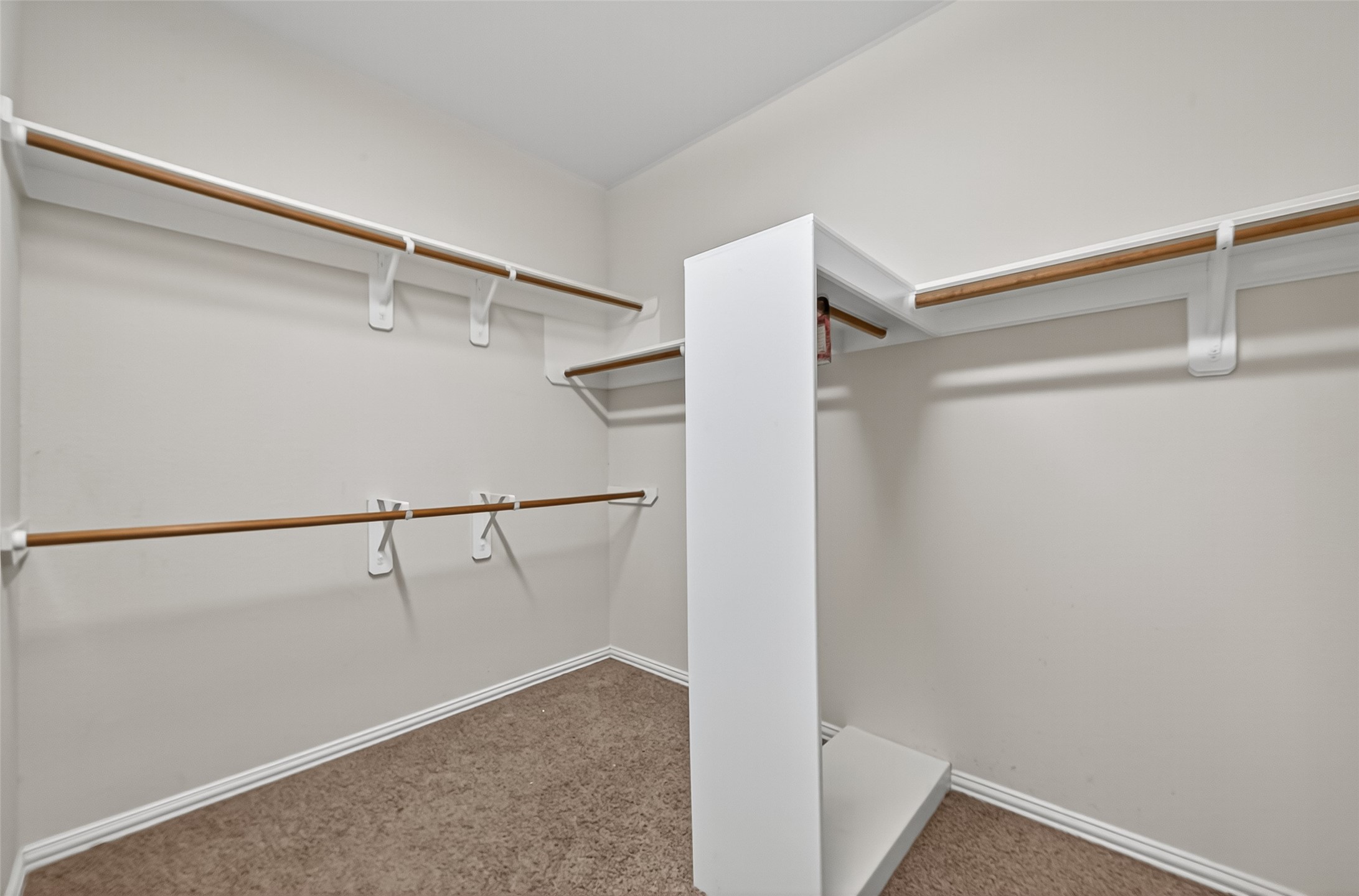 2019 Preston Park Rosenberg, TX 77471 - Photo 18 of 31 a view of walk in closet with empty racks
