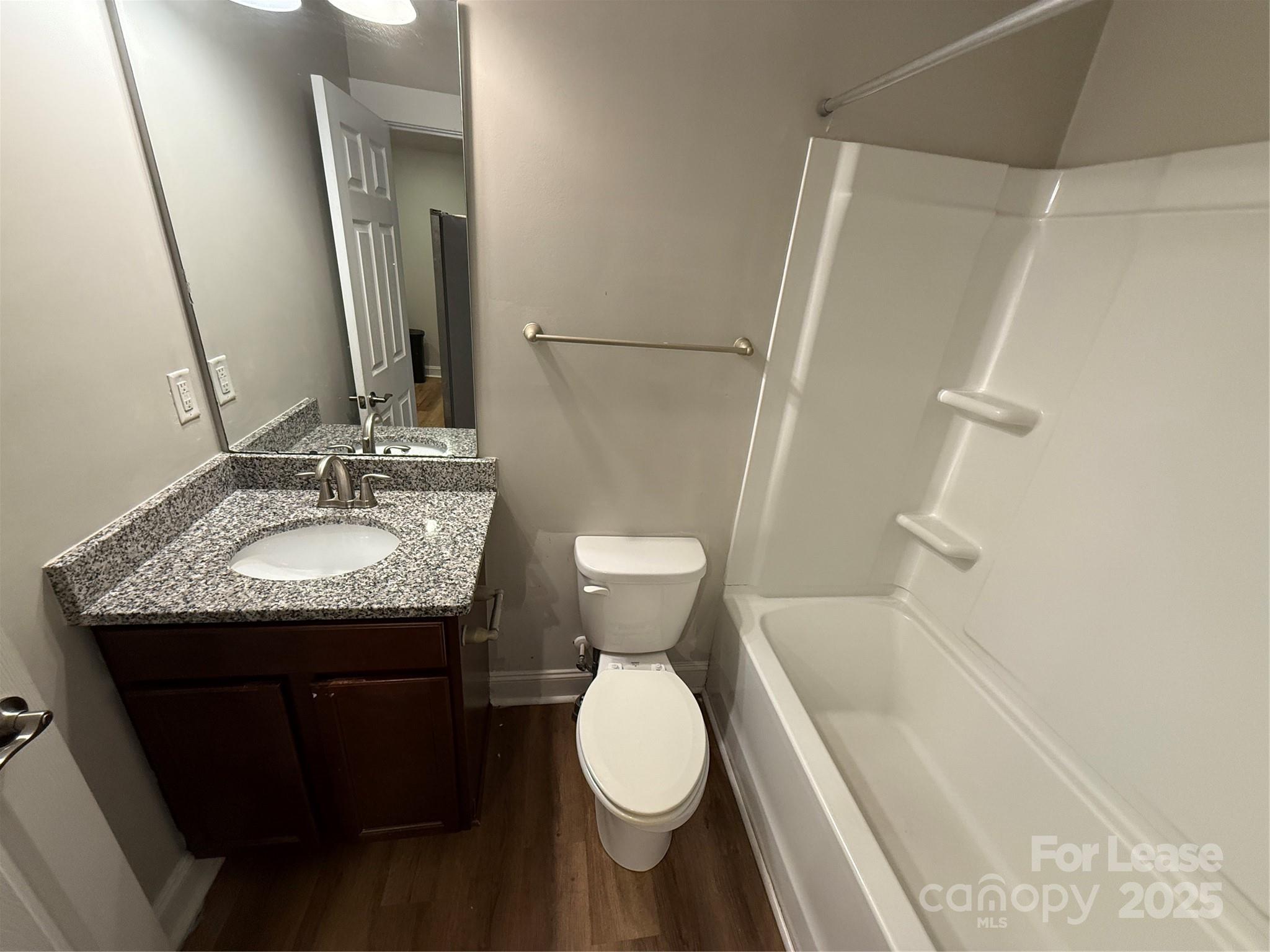 664 Reeves Court Charlotte, NC 28208 - Photo 6 of 9 a bathroom with a granite countertop sink toilet and shower