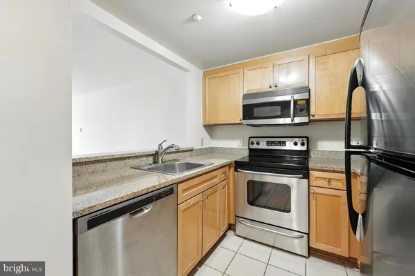 a kitchen with a sink stove and microwave