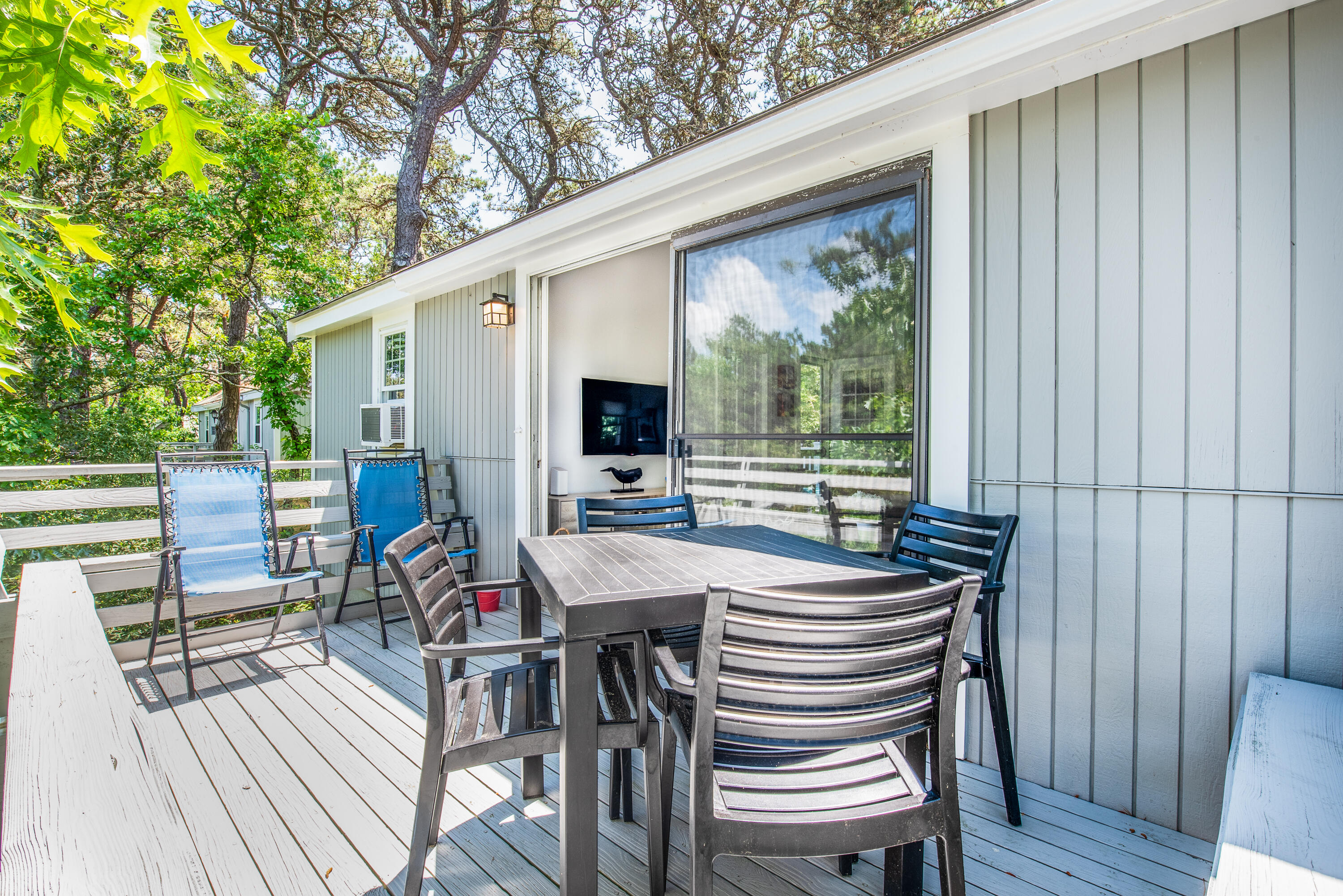 7 Great Hollow Road, Unit 38 Truro, MA 02666 - Photo 18 of 28 a view of a patio with table and chairs with wooden floor and fence