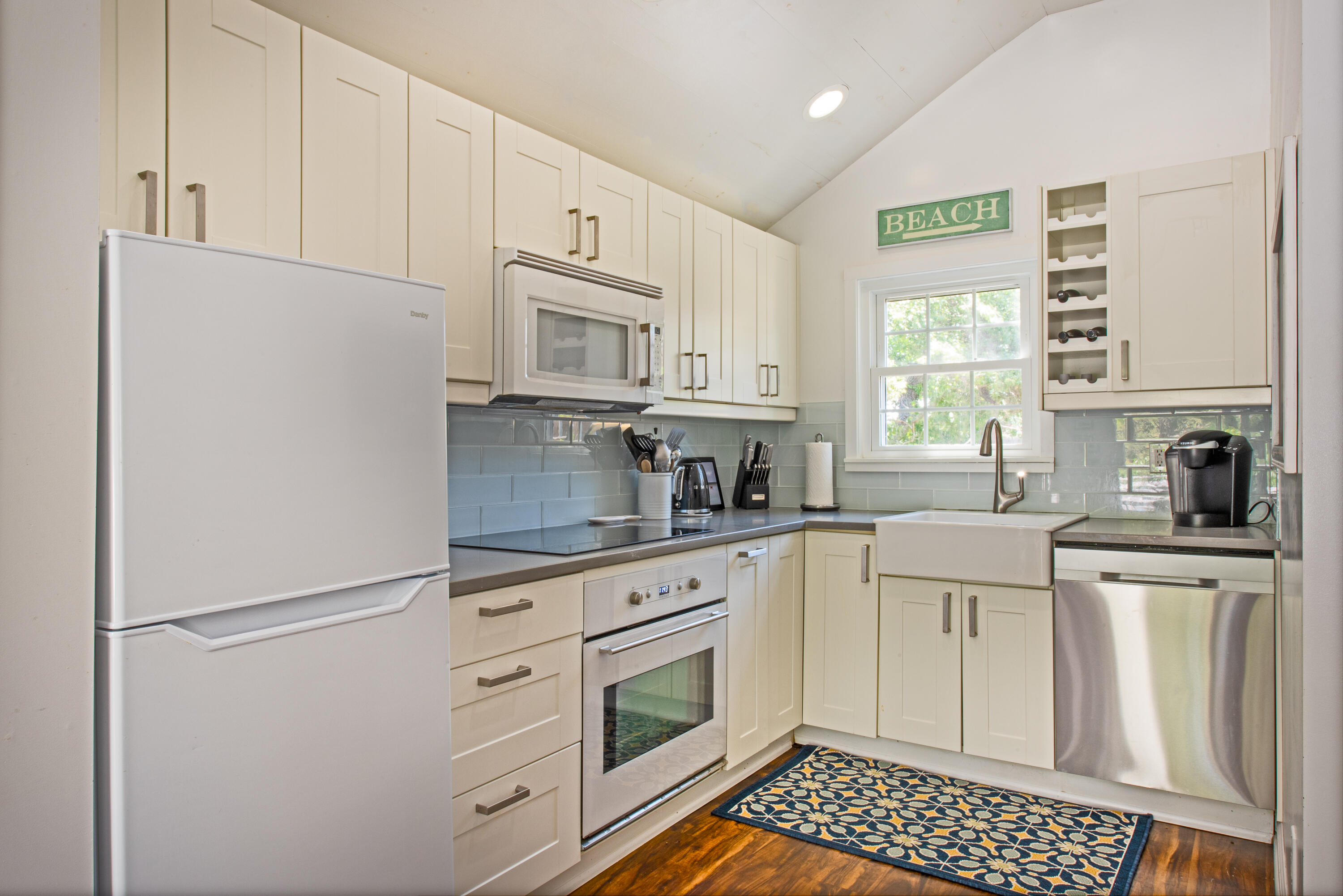 7 Great Hollow Road, Unit 38 Truro, MA 02666 - Photo 9 of 28 a kitchen with white cabinets and white appliances