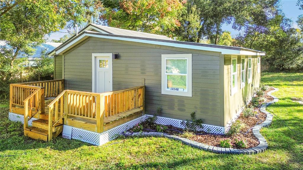14348 Graham Street Dade City, FL 33523 - Photo 1 of 36 a view of a house with backyard and sitting area