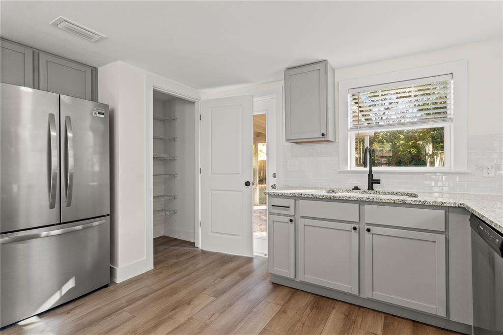 14348 Graham Street Dade City, FL 33523 - Photo 8 of 36 a kitchen with a refrigerator sink and cabinets