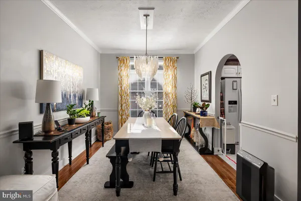 a bedroom with a bed wooden floor and a flat screen tv