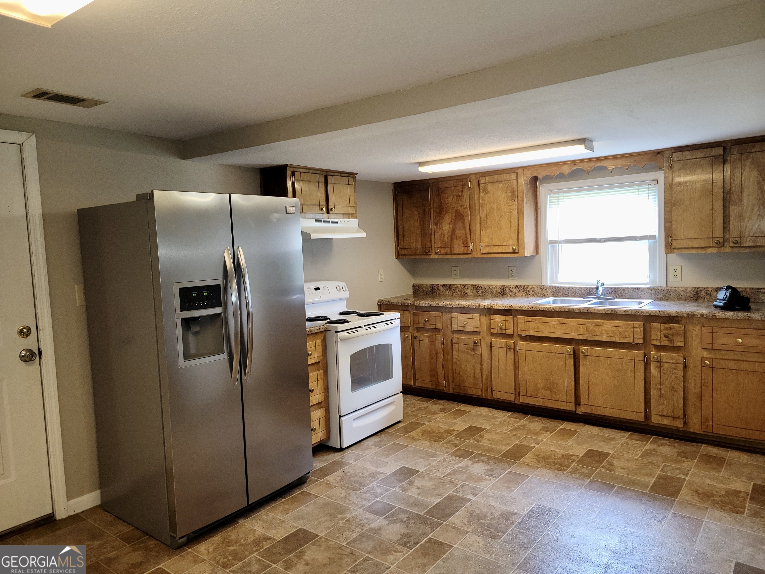 112 7th Street Trion, GA 30753 - Photo 16 of 28 a kitchen with stainless steel appliances granite countertop a stove a sink dishwasher a refrigerator and cabinets with wooden floor
