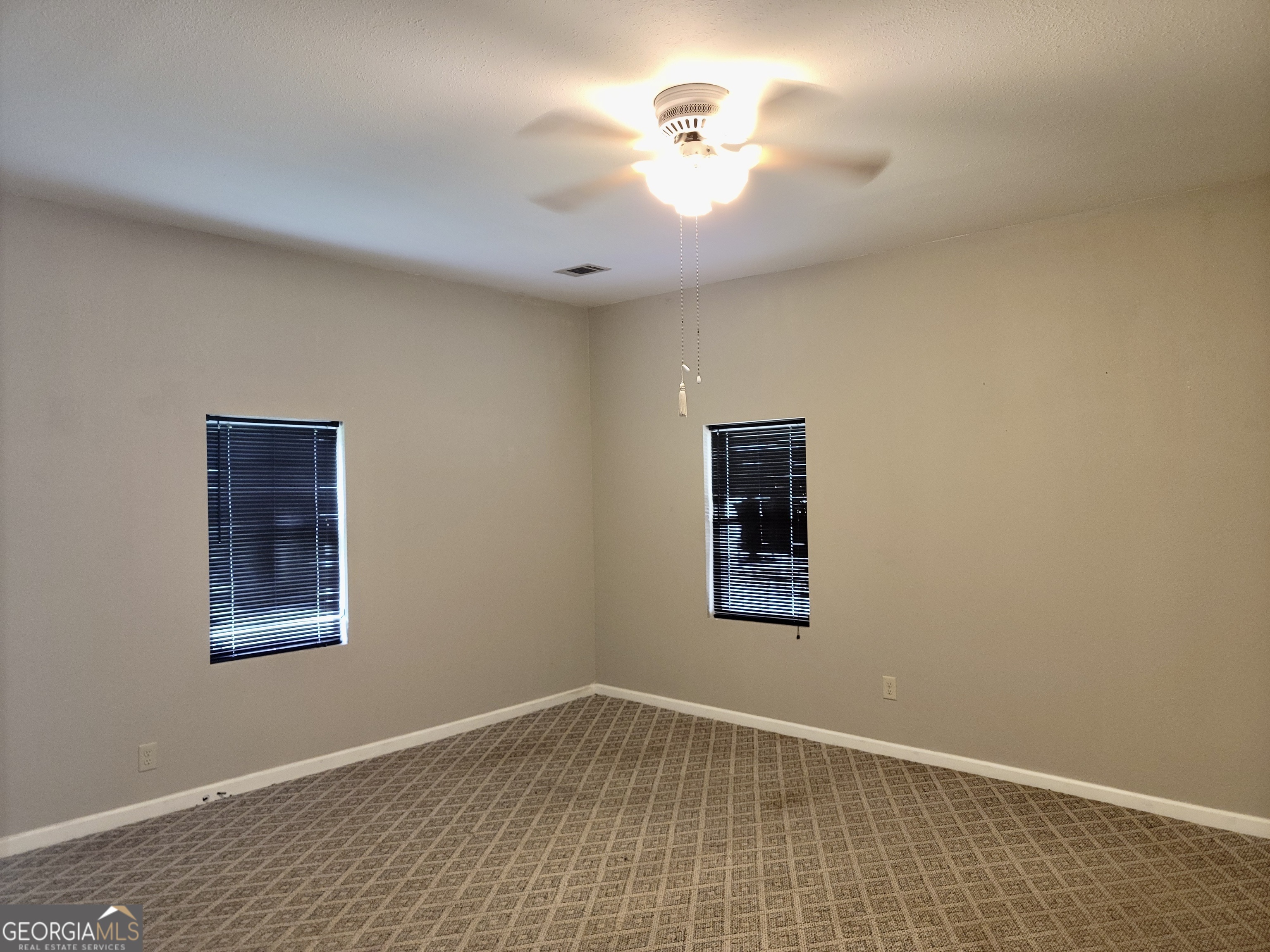 112 7th Street Trion, GA 30753 - Photo 20 of 28 an empty room with a window and a fan