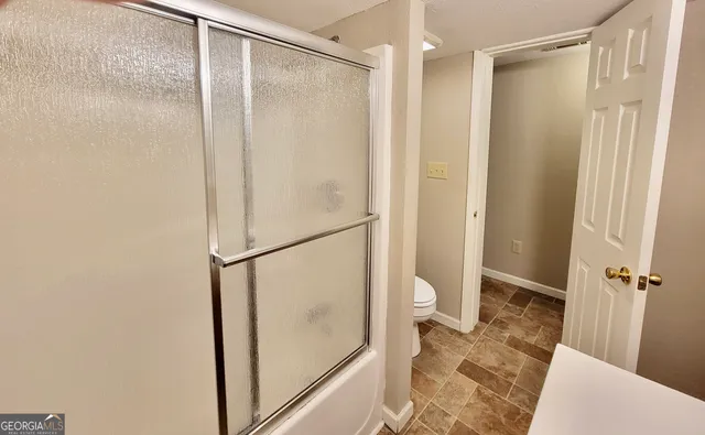 a bathroom with a glass shower door