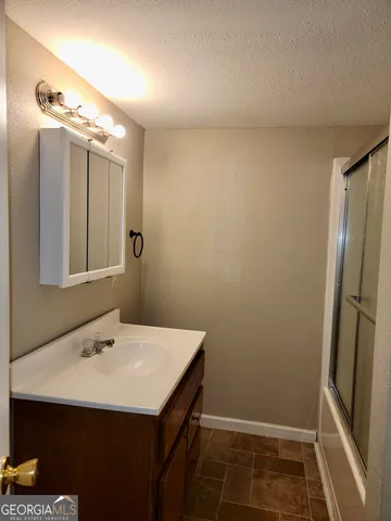 a bathroom with a sink and mirror