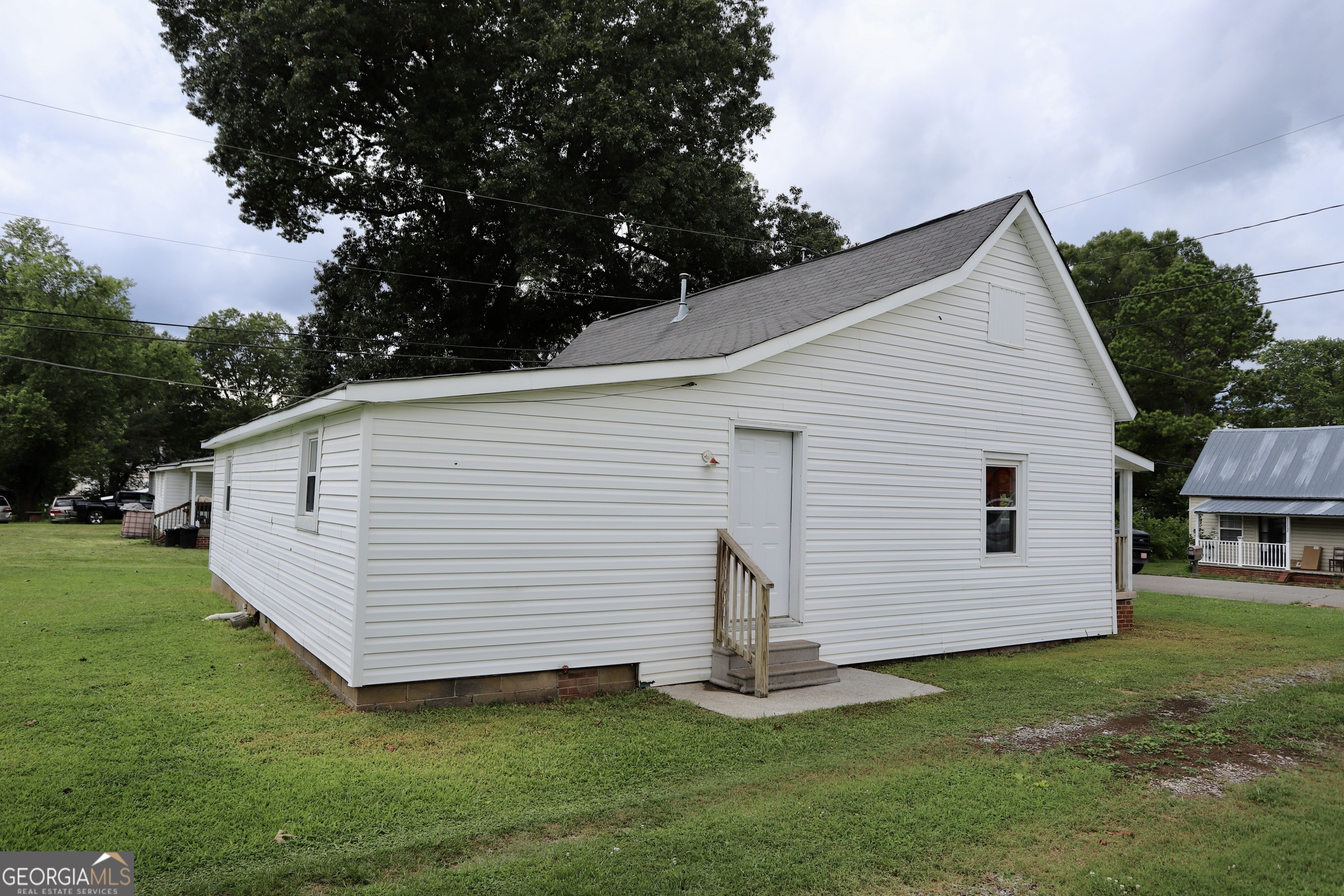 112 7th Street Trion, GA 30753 - Photo 8 of 28 a view of a white house with a yard