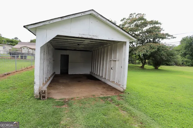 a view of a small house with a yard
