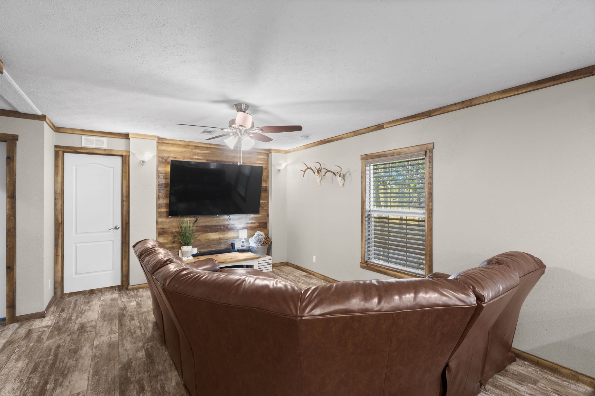 577 Winding River Road South Oakhurst, TX 77359 - Photo 13 of 31 a living room with furniture and a flat screen tv