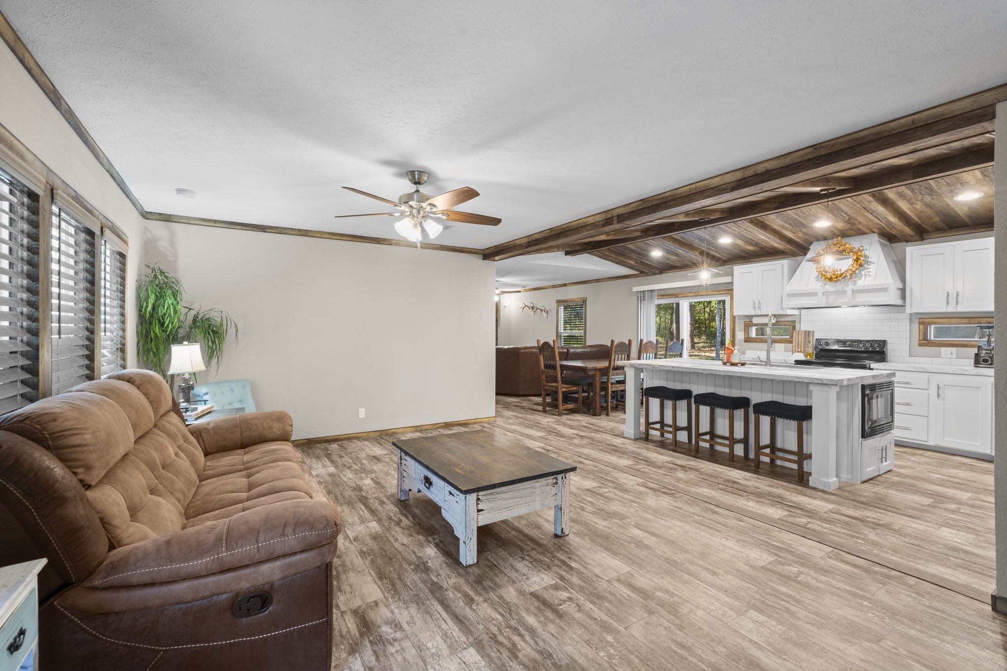 577 Winding River Road South Oakhurst, TX 77359 - Photo 6 of 31 a living room with furniture and a wooden floor