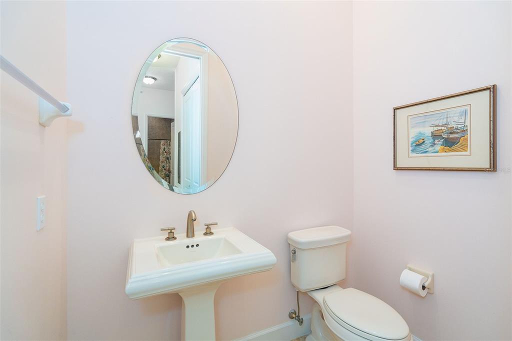 1375 Beach Road, Unit 309 Englewood, FL 34223 - Photo 14 of 45 a bathroom with a toilet a sink and mirror