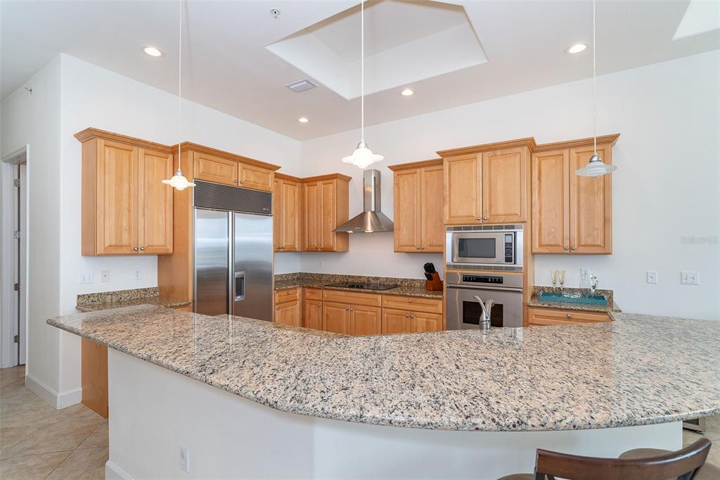 1375 Beach Road, Unit 309 Englewood, FL 34223 - Photo 16 of 45 a kitchen with stainless steel appliances granite countertop a sink stove and refrigerator